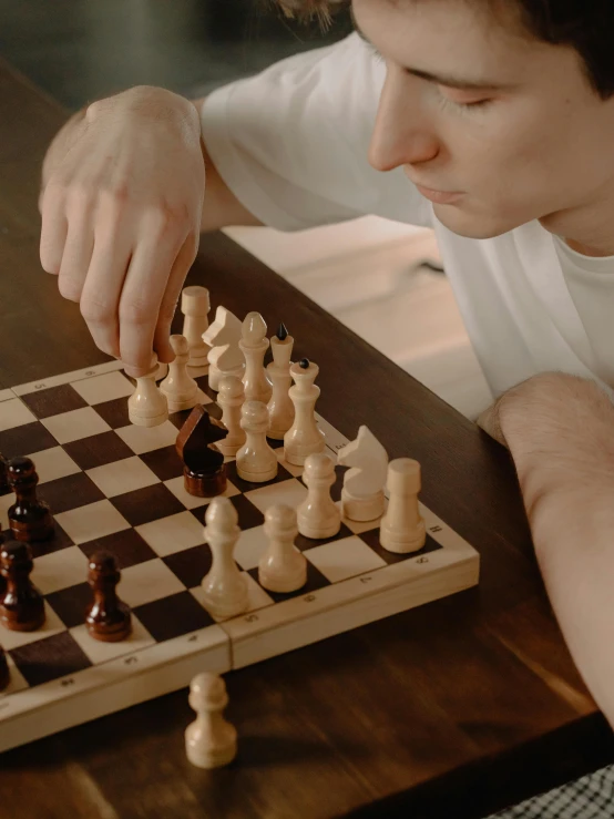 a young man playing a game of chess, pexels contest winner, board game cover art, thumbnail