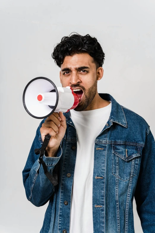 a man with a megaphone in his hand, trending on pexels, square masculine jaw, zayn malik, non binary model, wide mouth