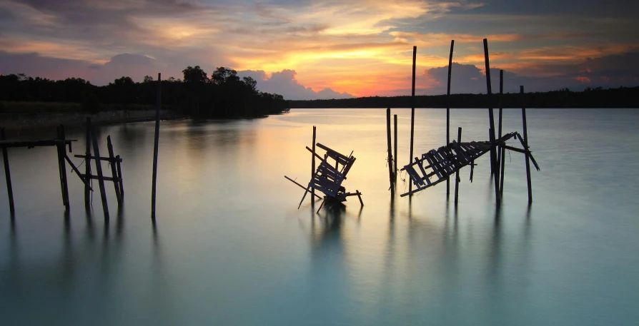 a boat sitting on top of a body of water, an album cover, pexels contest winner, hurufiyya, lagoon, shipwrecks, evening light, singapore