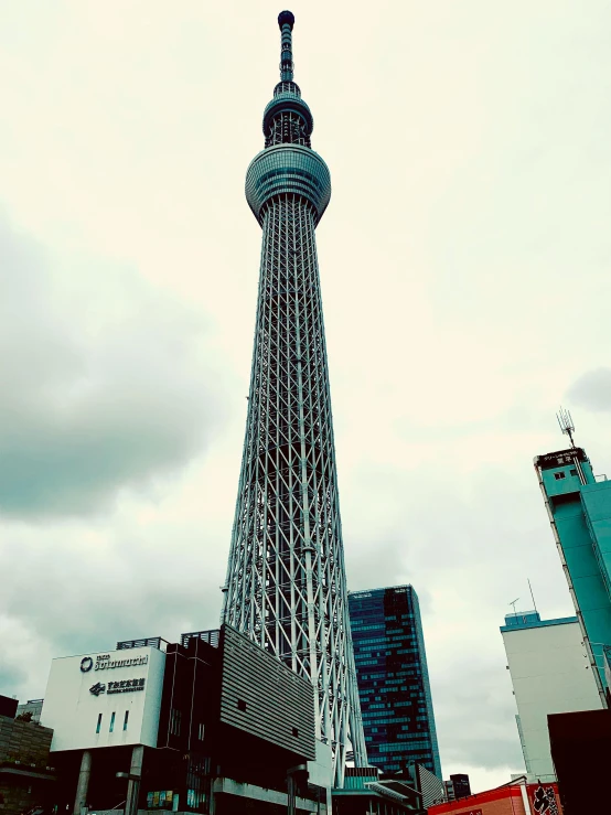 a tall tower sitting in the middle of a city, inspired by Kōshirō Onchi, unsplash contest winner, ukiyo-e, 🚿🗝📝