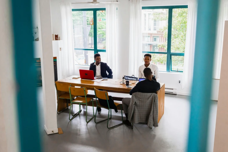 two men sitting at a table with laptops, by Sebastian Vrancx, pexels contest winner, cubical meeting room office, standing still, group sit at table, alphonse muca