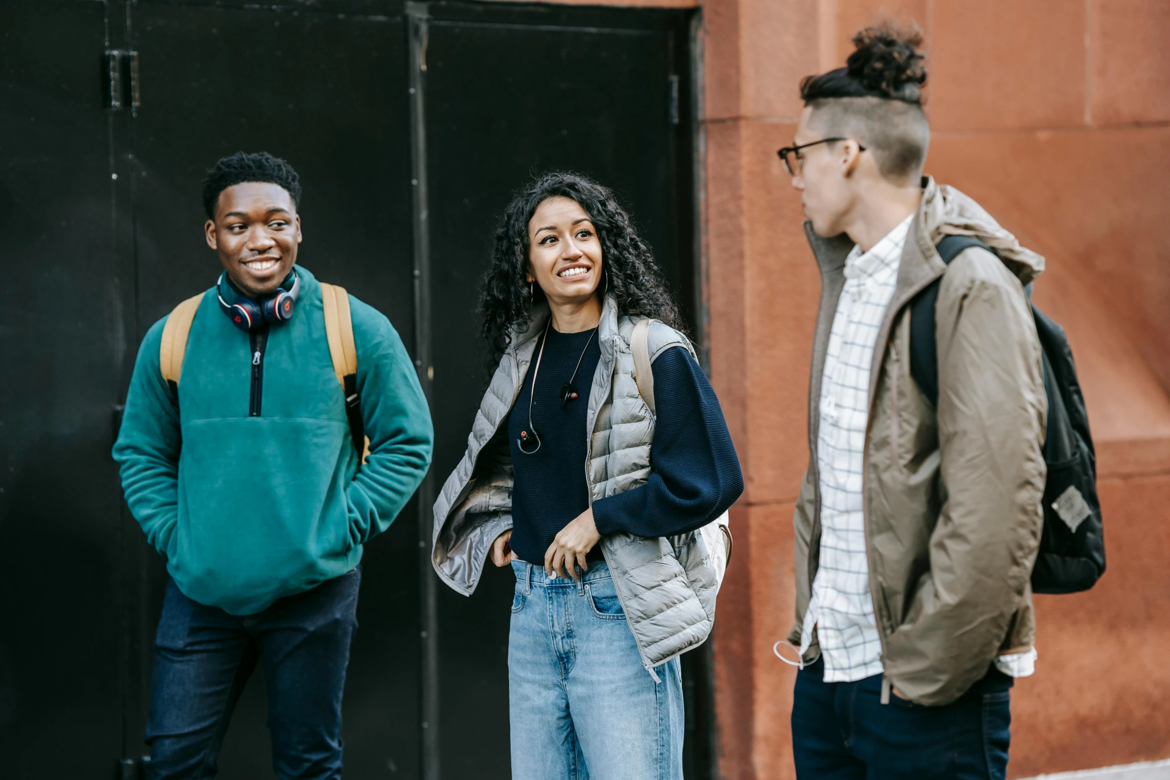 a group of people standing in front of a building, trending on pexels, black teenage boy, academic clothing, smiling at each other, charli bowater and artgeem
