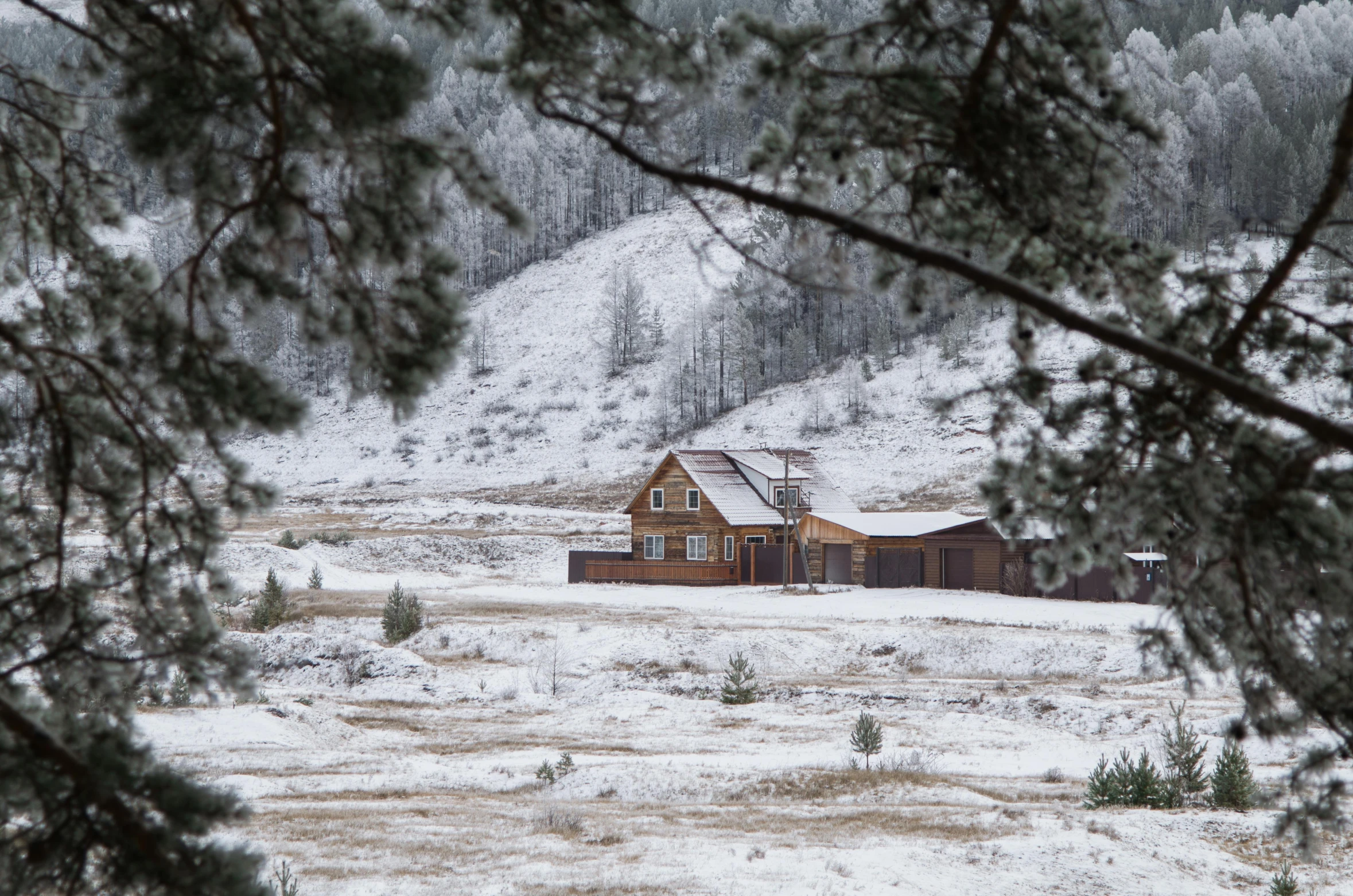 a house sitting in the middle of a snow covered field, by Jessie Algie, pexels contest winner, renaissance, near lake baikal, dusting of snow, hunting, 2 0 2 2 photo