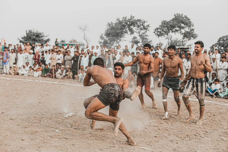 a group of men playing a game of wrestling, an album cover, pexels contest winner, tribals, martial arts tournament, dusty ground, very extremely beautiful