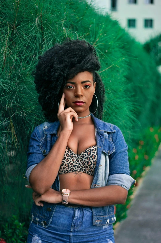 a woman standing on a sidewalk talking on a cell phone, an album cover, pexels contest winner, renaissance, sexy girl with dark complexion, wild hairstyle, lush greens, wearing a crop top