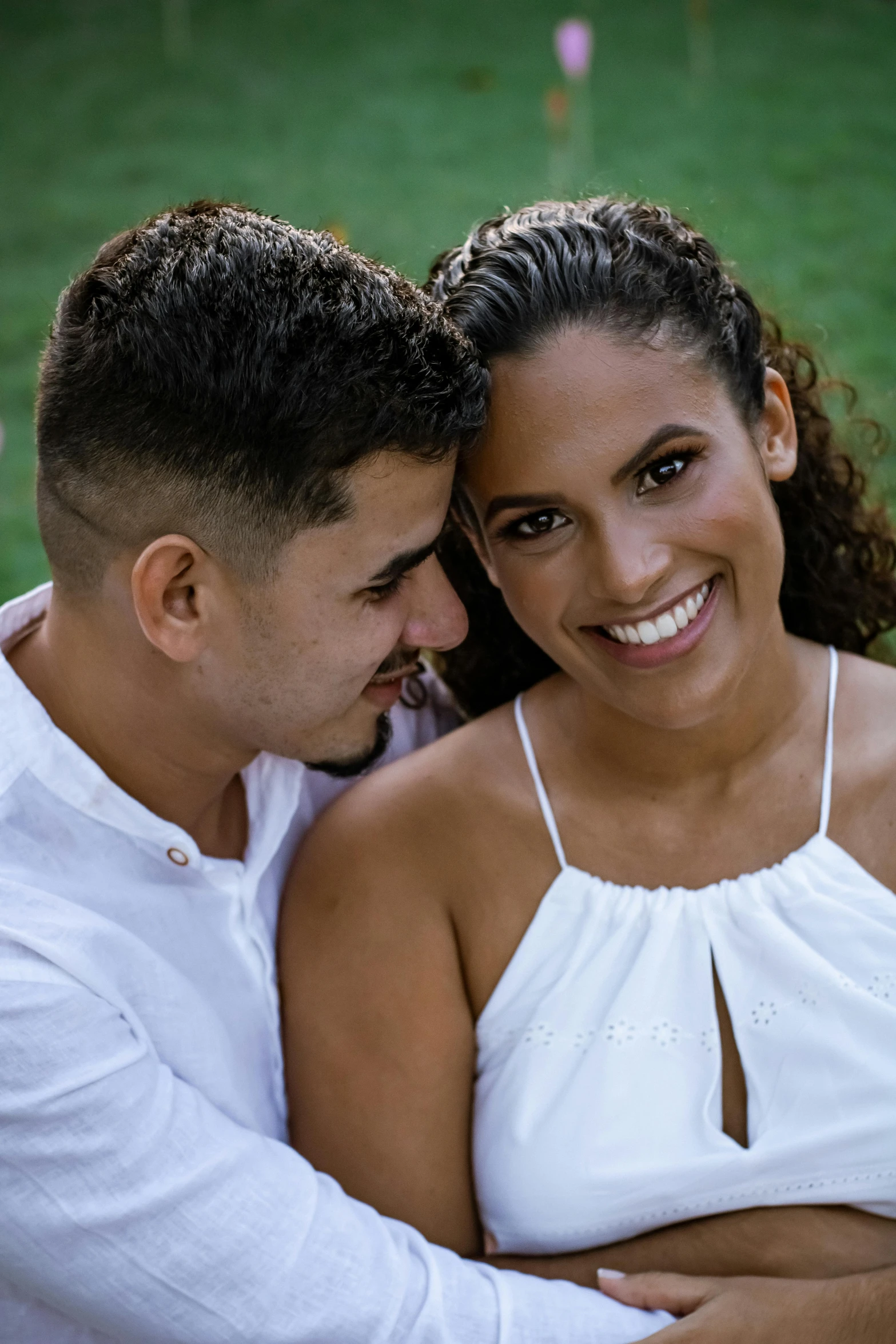 a man and a woman sitting next to each other, a portrait, inspired by Gina Pellón, pexels contest winner, smiling :: attractive, puerto rico, detailed white, lawn