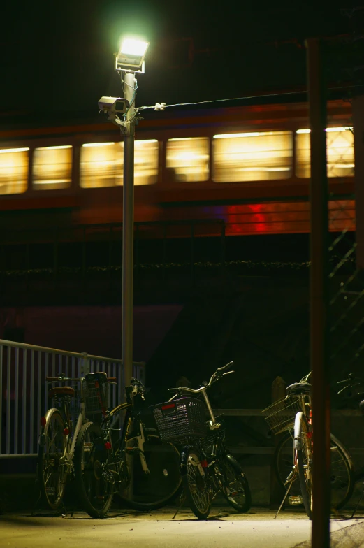 a train passing over a bridge at night, by Tadashige Ono, flickr, bicycles, low detail, bus station, taken in the late 2010s