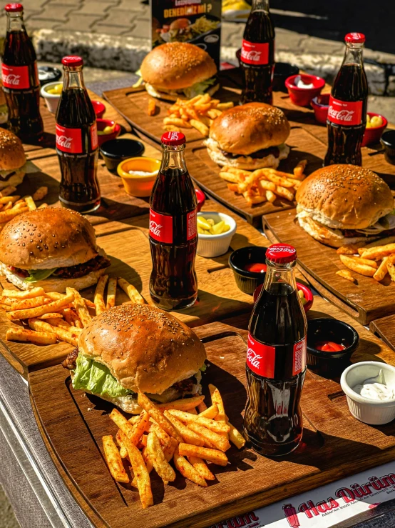 a table topped with lots of burgers and fries, black and red only!!!, hamburgers and soda, highly upvoted, corporate