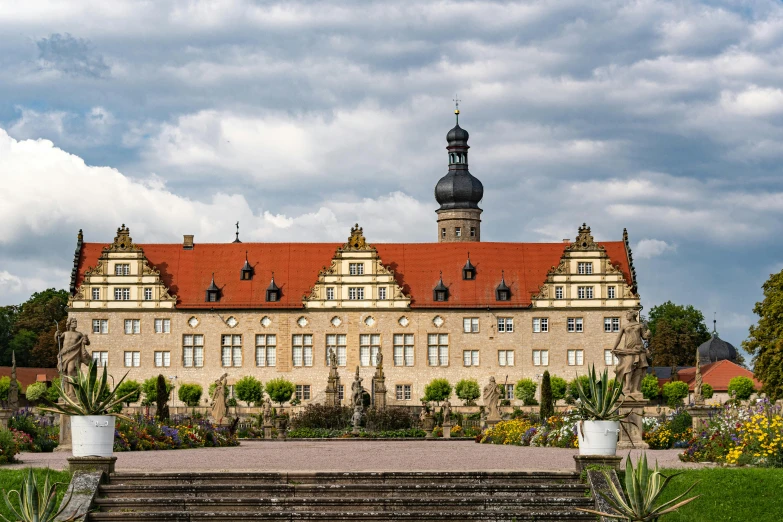 a large building sitting on top of a lush green field, by Matthias Stom, pexels contest winner, baroque, square, nuremberg, high quality image, slight overcast weather