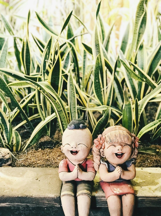 a couple of figurines sitting next to each other, by Lucia Peka, unsplash, spirited water plants, bright smiles, nostalgic vibes, sangyeob park