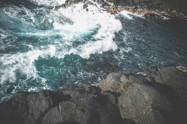 a large body of water next to a rocky shore, pexels contest winner, happening, whirlpool, ocean spray, thumbnail, high picture quality