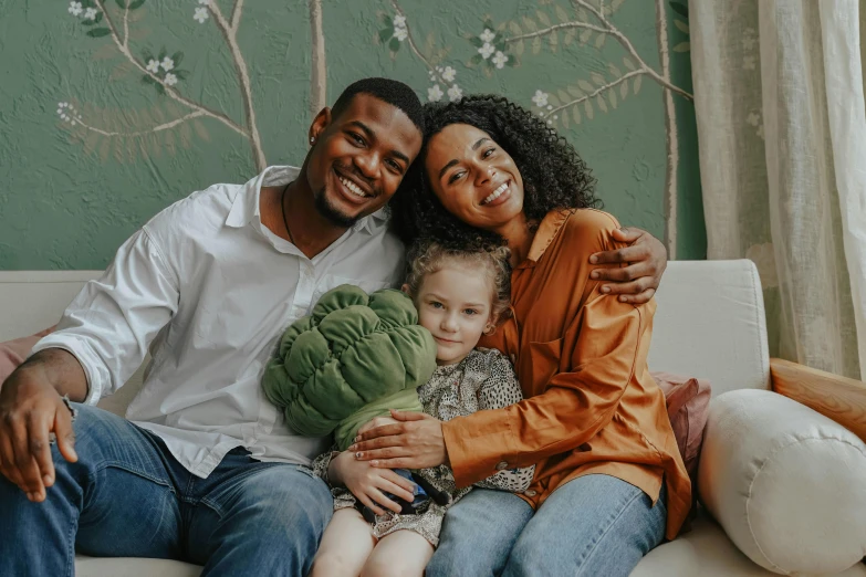 a man and woman sitting on a couch with a child, pexels contest winner, renaissance, mixed race, hugging each other, avatar image, group of people