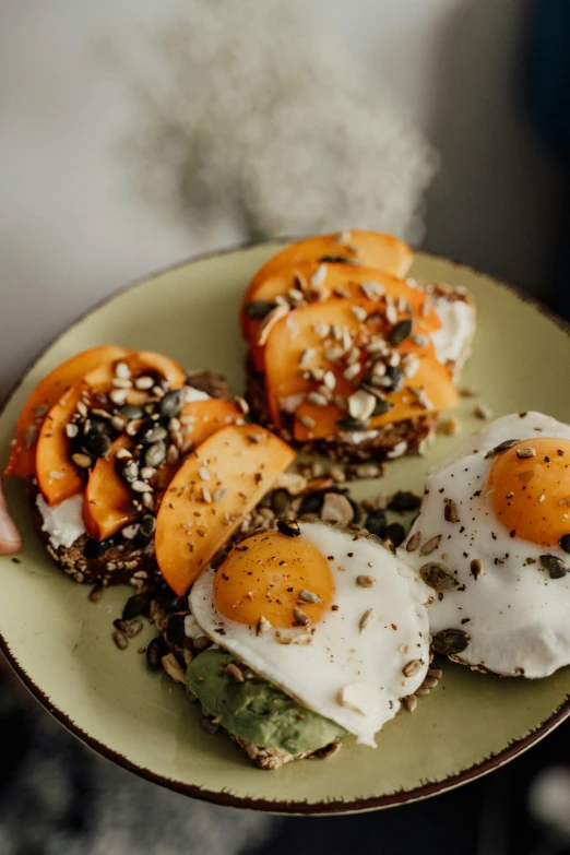 a person holding a plate of food with eggs and avocado, by Jan Tengnagel, unsplash, renaissance, peaches, sexy sesame seed buns, thumbnail, orange grey white