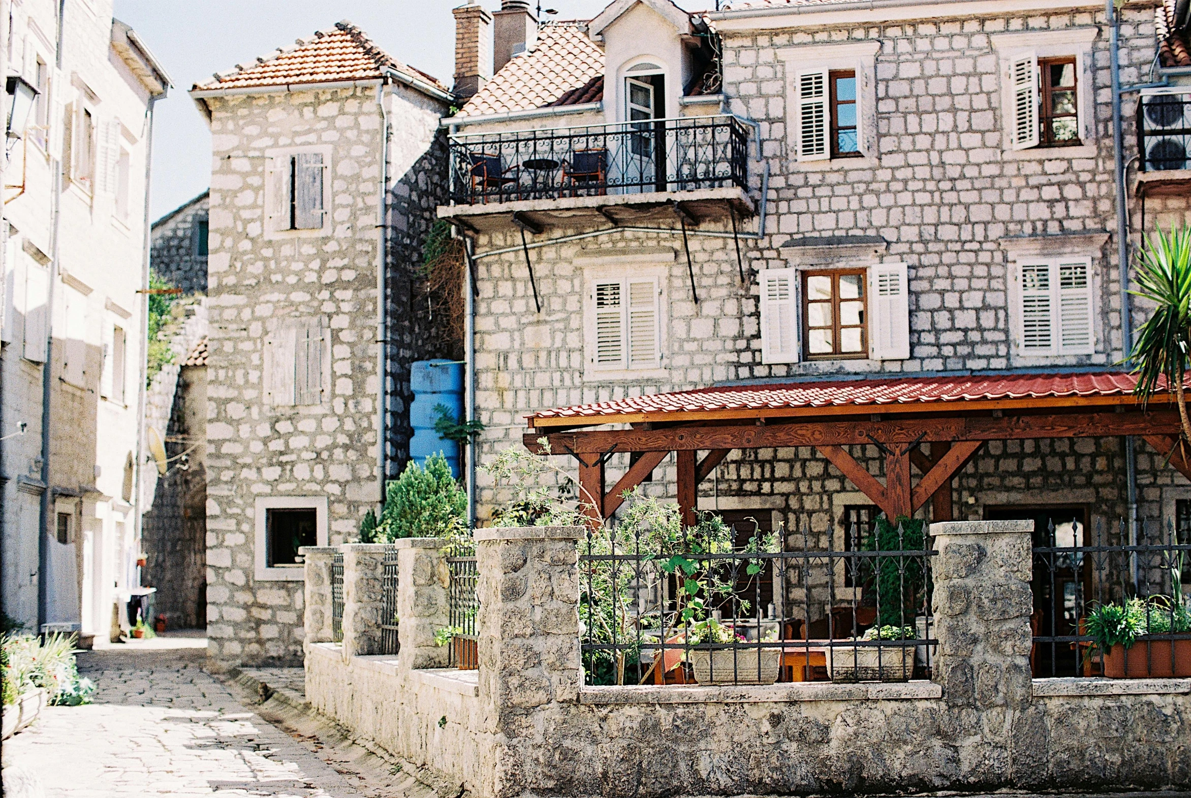 a couple of buildings that are next to each other, a photo, pexels contest winner, romanesque, boka, homes and gardens, made from old stone, 1980s photo