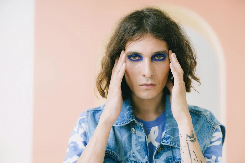 a close up of a person with blue eyes, an album cover, by Elsa Bleda, pop art, androgynous person, mullet, smoky, drugstore