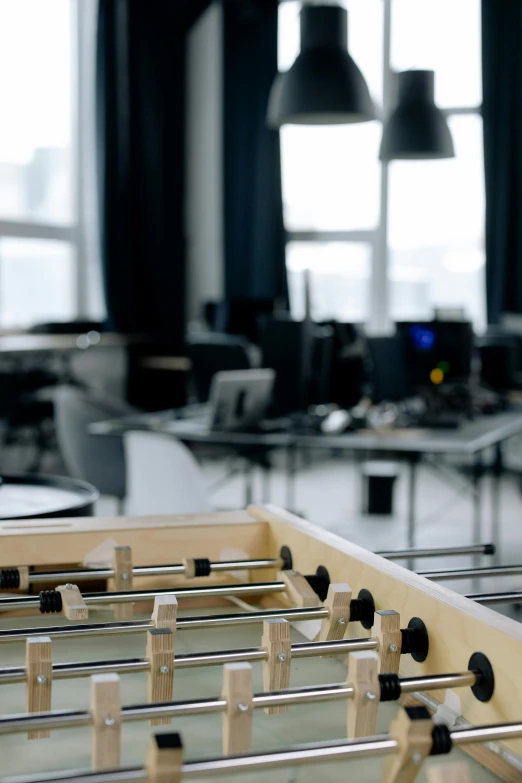 a close up of a foosball table in a room, arbeitsrat für kunst, open office, thumbnail, overlooking, cinematic