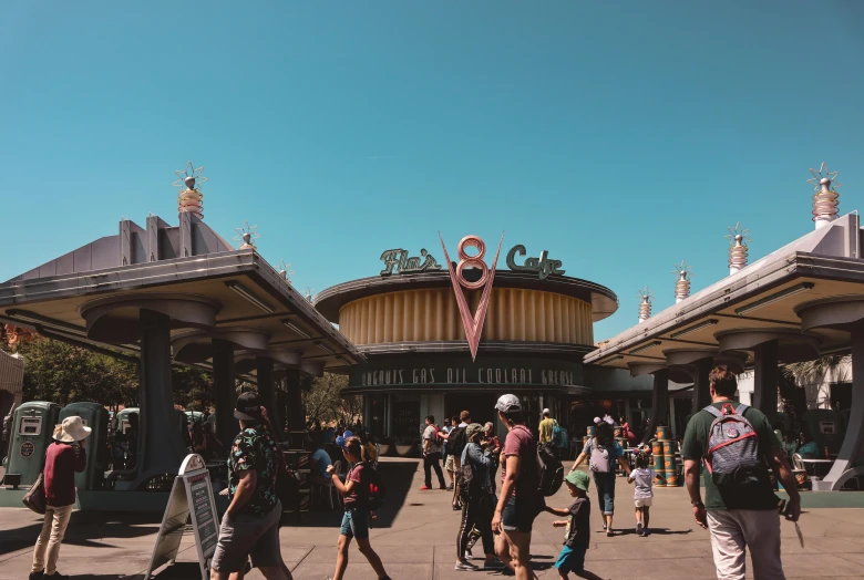 a group of people walking in front of a building, theme park, vsco, at california adventure, avatar image