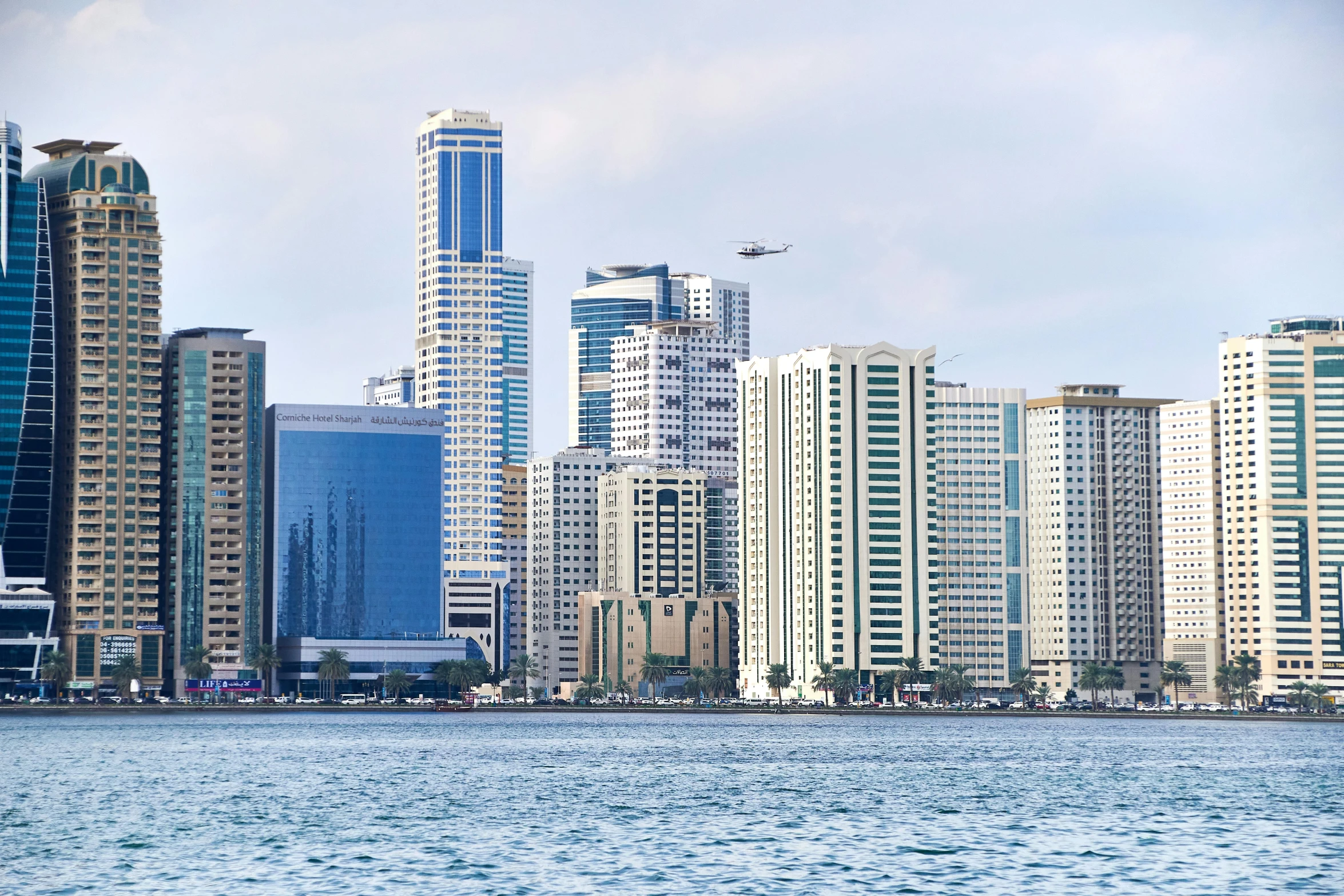 a large body of water with a bunch of tall buildings in the background, pexels contest winner, hurufiyya, gulf, pr shoot, high quality product image”, multiple stories