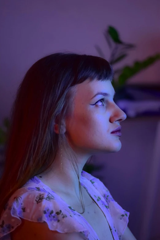a woman sitting in front of a computer monitor, an album cover, unsplash, violet lighting, ((portrait)), anna podedworna, sideview