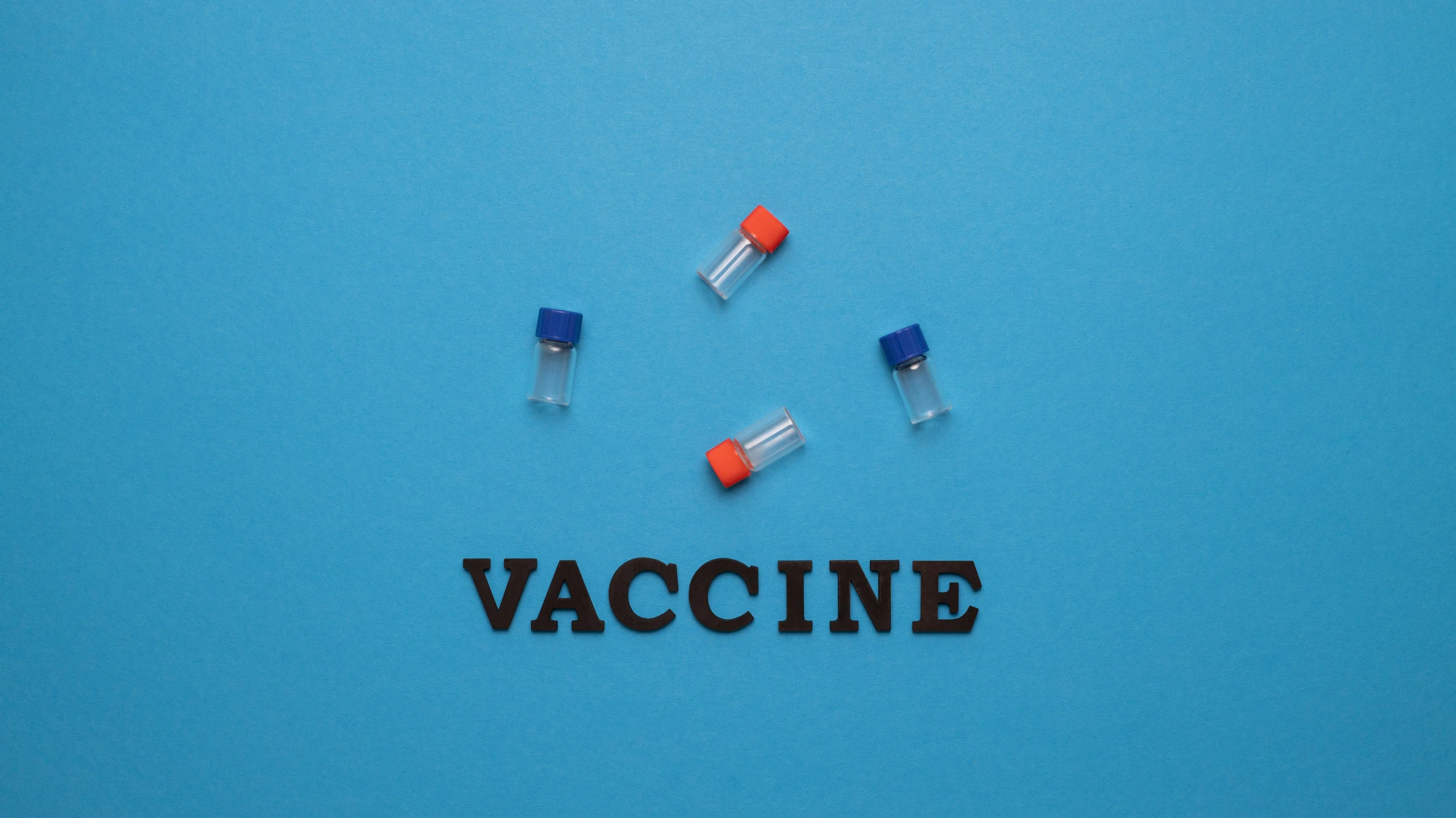 a group of vials sitting on top of a blue surface, an album cover, shutterstock, iv pole, vacuum, word, pandemic