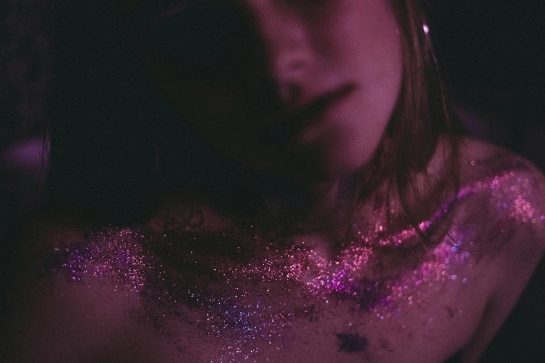 a close up of a woman with glitter on her body, an album cover, inspired by Elsa Bleda, trending on pexels, digital art, magenta colours, astral projection, teenage girl, grainy film photo