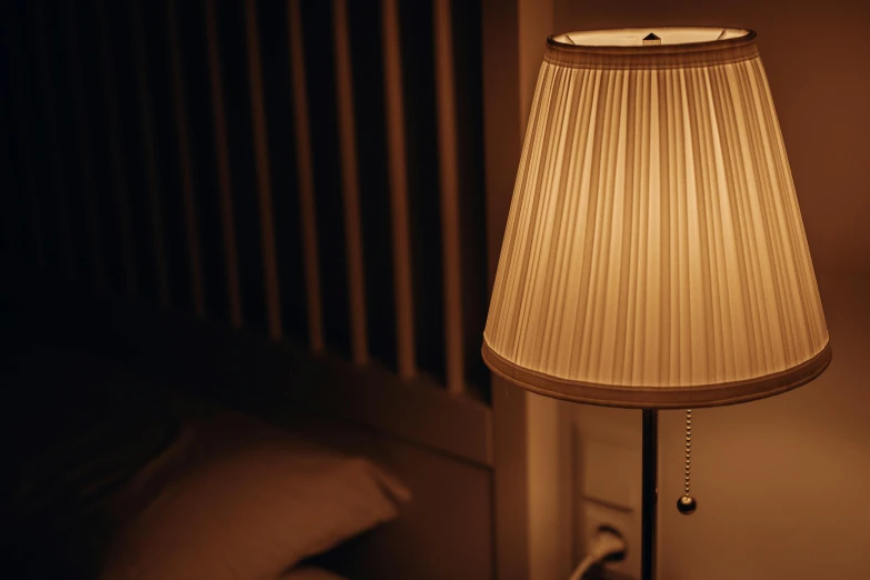 a lamp that is sitting next to a bed, pexels contest winner, soft evening lighting, one single lamp, soft light - n 9, close angle