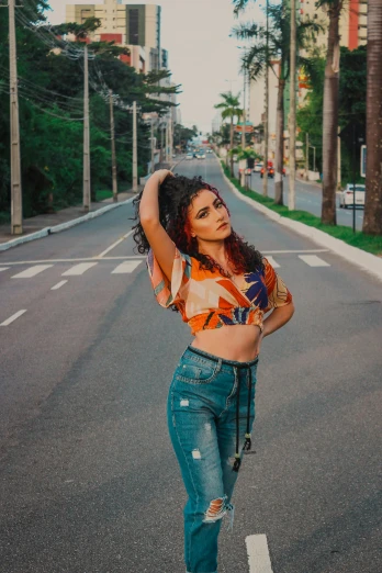 a woman standing in the middle of a street, pexels contest winner, wearing a crop top, alanis guillen, jeans, portait of haifa wehbe