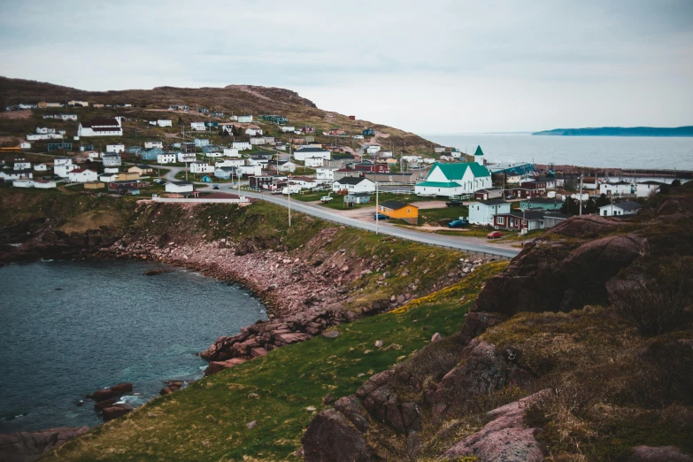 a small town next to a body of water, sarenrae, fan favorite, coastline, top selection on unsplash