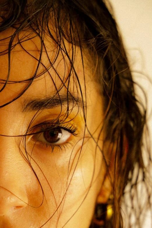 a close up of a woman with wet hair, an album cover, trending on pexels, hyperrealism, eyes are yellow, bedhead, 33mm photo, concept photo