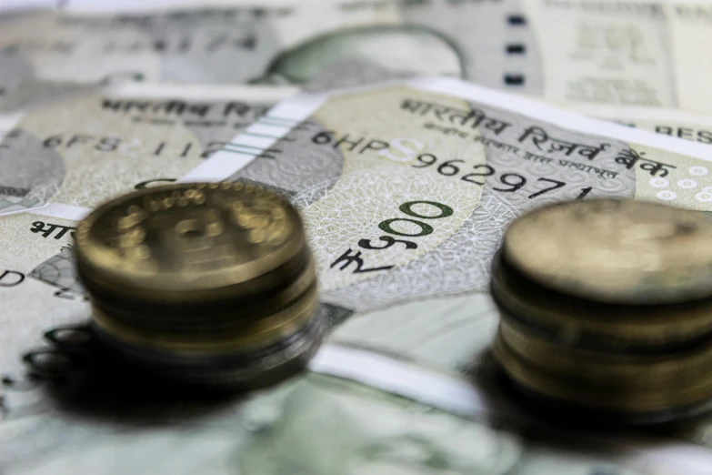 a pile of money sitting on top of a pile of coins, unsplash, hurufiyya, india, zoomed view of a banknote, 15081959 21121991 01012000 4k, thumbnail