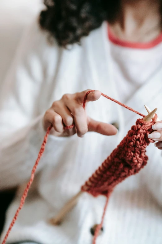 a woman is knitting a red piece of yarn, by Niko Henrichon, pexels contest winner, instagram post, promo image, multi-part, royal commission