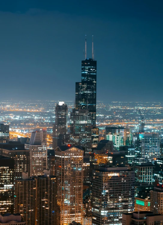 a view of a city at night from the top of a building, chicago skyline, slide show, tall, getty images proshot