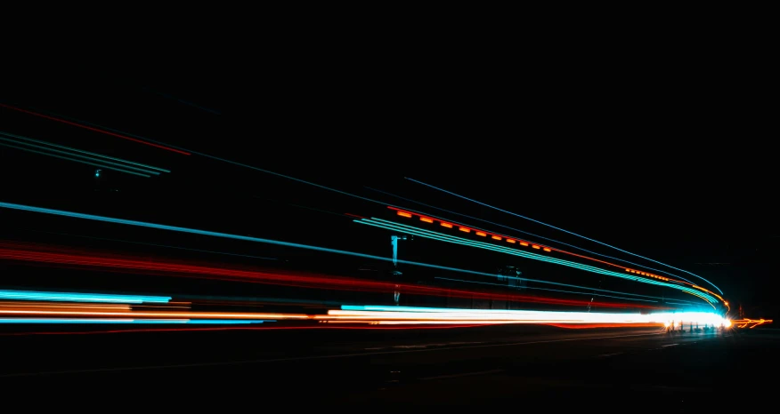 a blurry image of a city street at night, unsplash, visual art, orange and cyan lighting, speed lines, with a black background, lines of energy