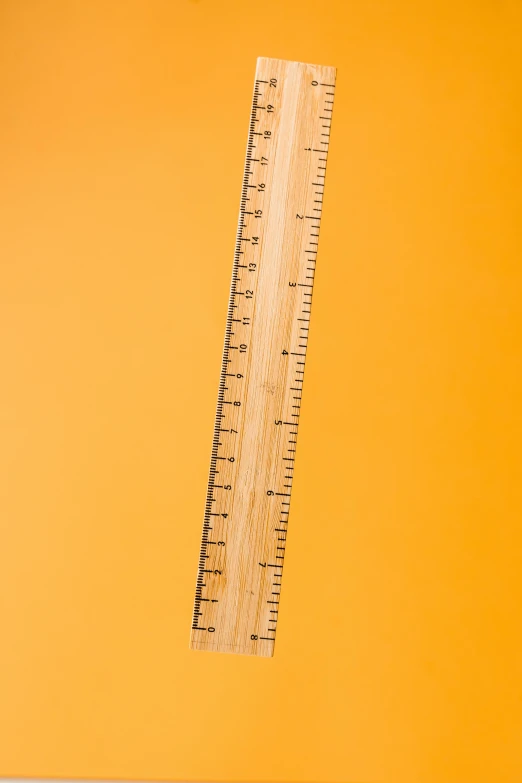 a wooden ruler on a yellow background, by Gavin Hamilton, unsplash, square lines, very tall, giant wooden club, orange: 0.5