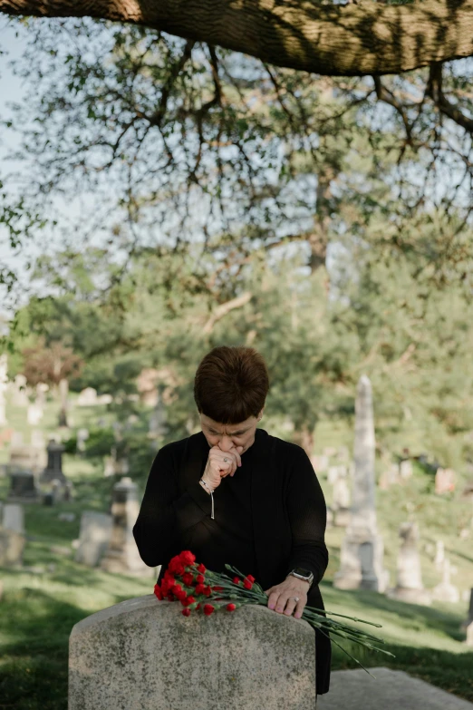 a woman kneeling at a grave in a cemetery, unsplash, holding a red rose, multiple stories, sad men, profile image