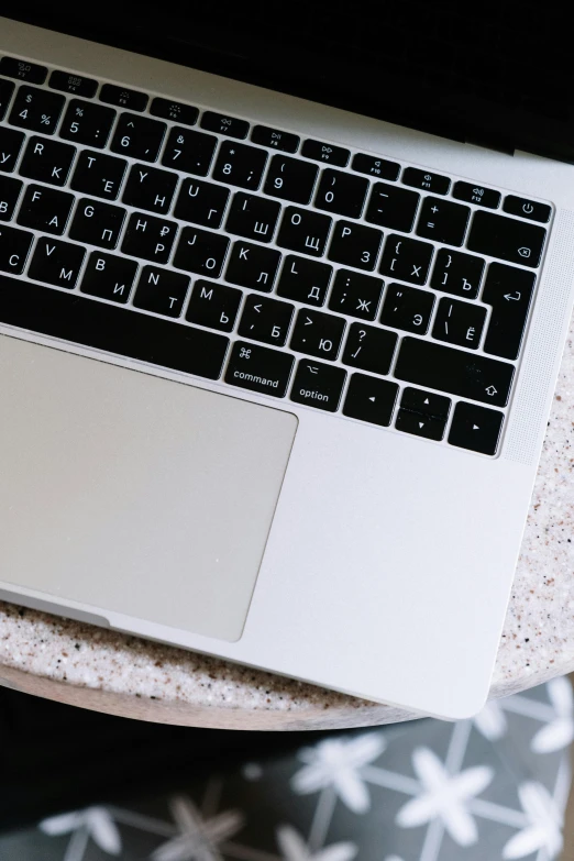 a laptop computer sitting on top of a wooden table, by Carey Morris, pexels, square, lacquered, cream, apple