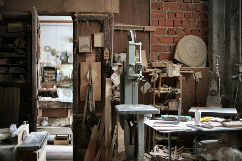 a room filled with lots of clutter and tools, by Jan Tengnagel, unsplash, arts and crafts movement, tall factory, natural materials, ignant, saws