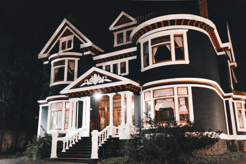a black and white house lit up at night, pexels contest winner, art nouveau, gilmore girls aesthetic, brown, night color, exterior view