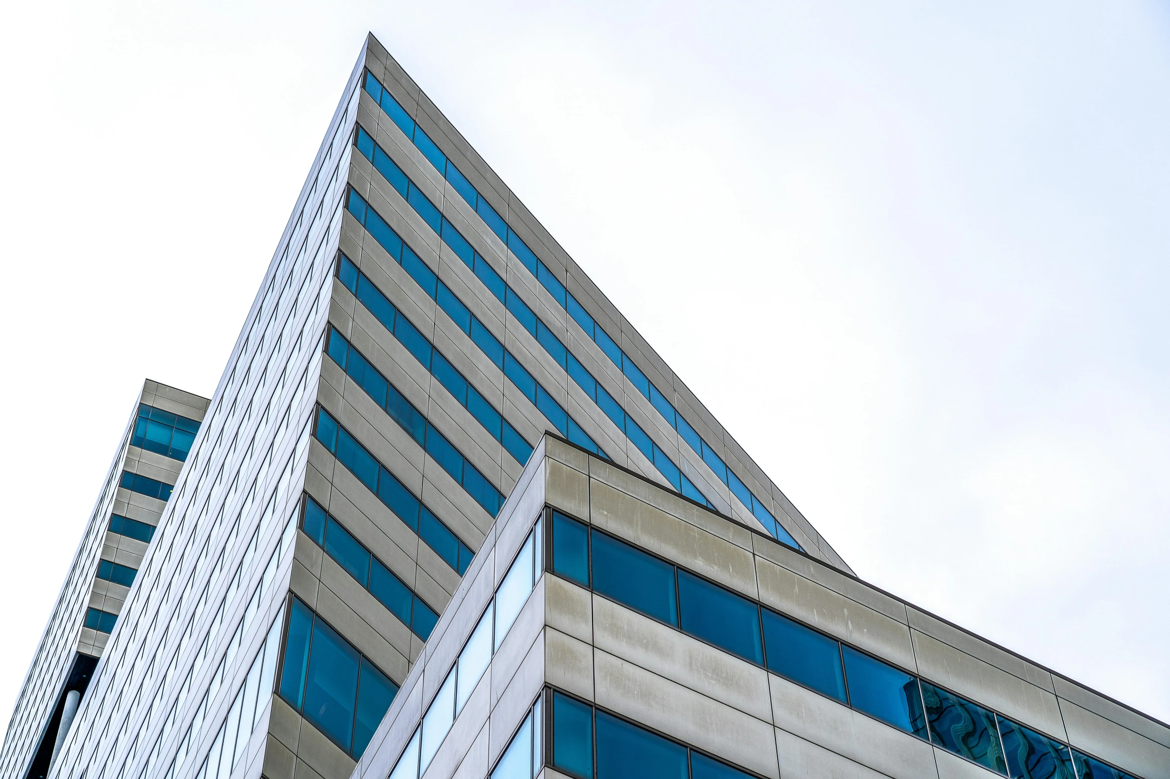 a couple of tall buildings next to each other, a picture, unsplash, modernism, square jaw-line, espoo, low angle photograph, commercial