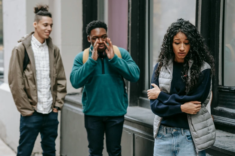 a woman standing on the side of a street talking on a cell phone, trending on pexels, renaissance, black teenage boy, 3 actors on stage, bullying, school class