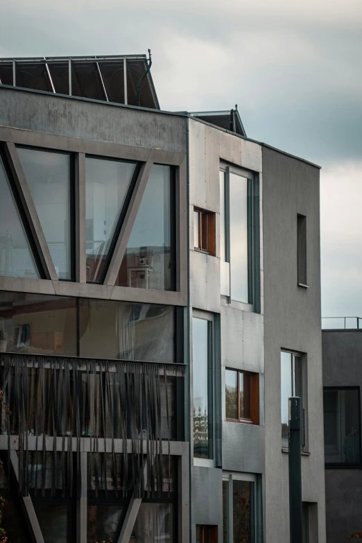 a couple of buildings that are next to each other, inspired by János Nagy Balogh, unsplash, brutalism, steel window mullions, exterior photo, zoomed, 2045