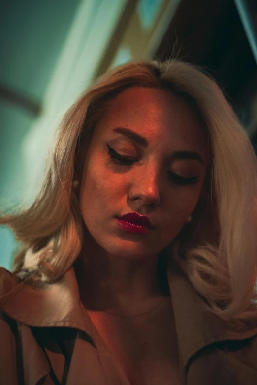 a woman in a trench coat looking at her cell phone, an album cover, inspired by Elsa Bleda, trending on pexels, photorealism, face like marilyn monroe, portrait of vanessa morgan, white haired lady, night time low light