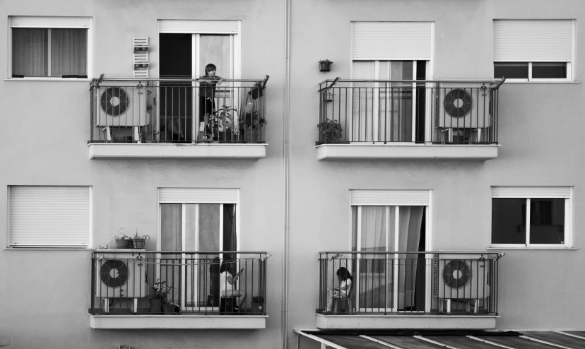 a black and white photo of a building with balconies, by Joze Ciuha, pexels contest winner, parents watching, at home, three views, flat