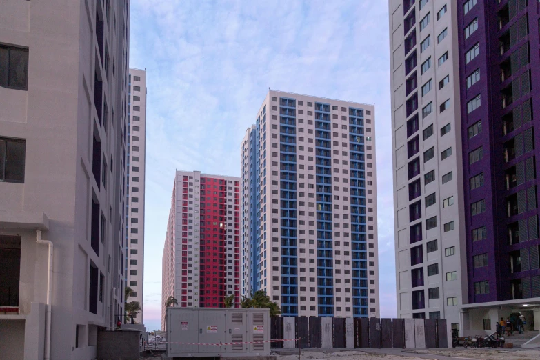 a group of tall buildings sitting next to each other, an album cover, unsplash, hyperrealism, multicoloured, concrete housing, guangjian, 2 0 2 2 photo