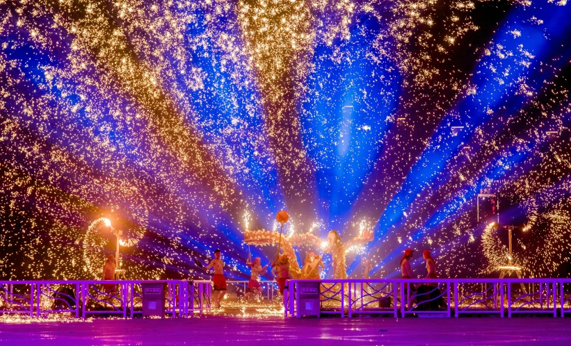 a group of people standing on top of a stage, by Julia Pishtar, pexels contest winner, light and space, purple fire around magic arena, thailand, sparkles all around, photograph of enchanted garden