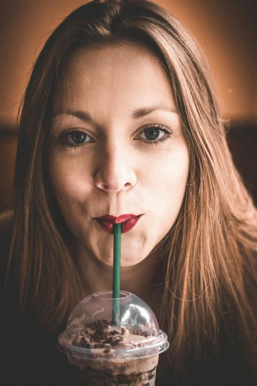 a woman drinking a drink out of a plastic cup, by Matthias Stom, pexels contest winner, renaissance, large full lips, avatar image, starbucks, with a straw