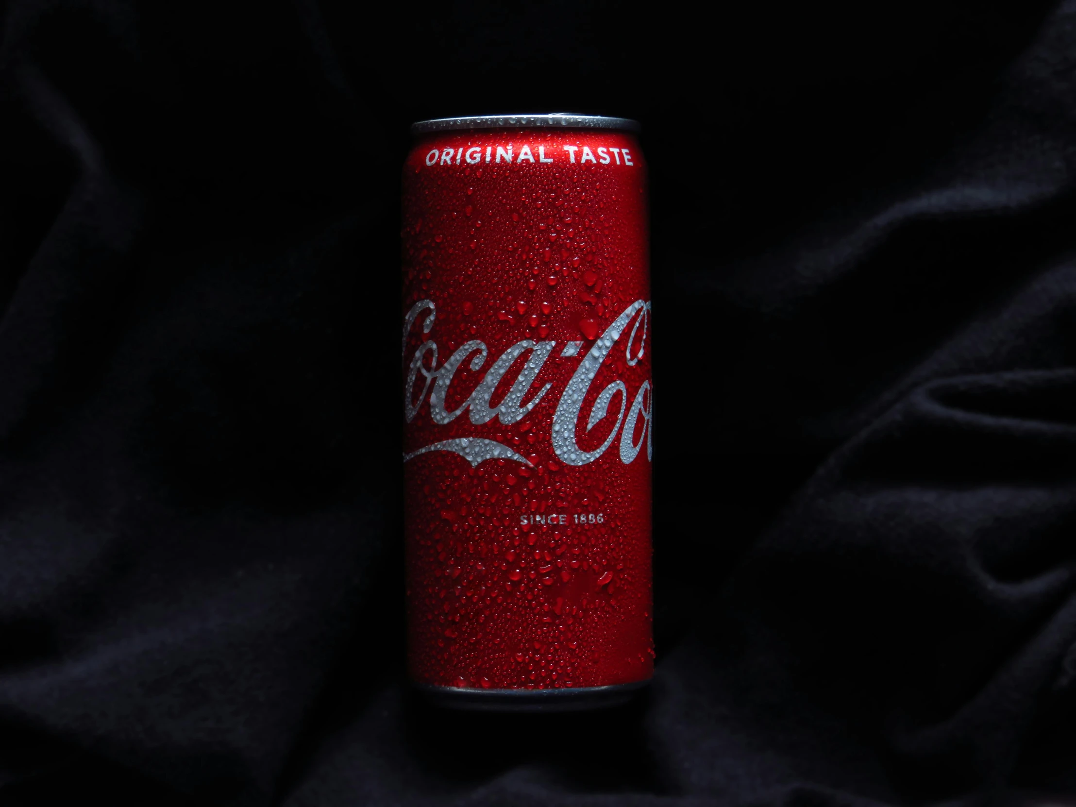 a can of coca cola sitting on a black cloth, pexels contest winner, detailed product image, metallic red, authentic, cccp