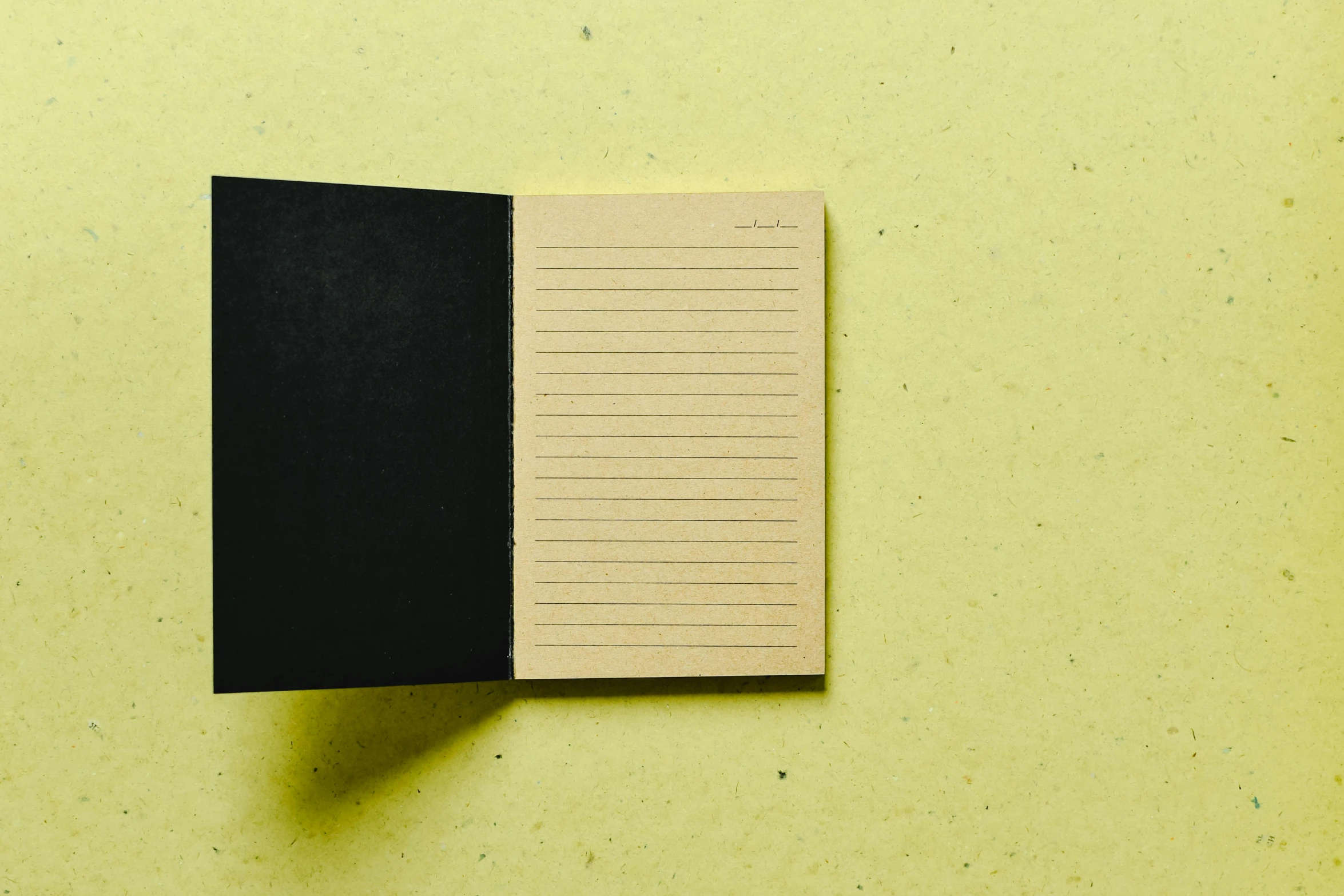 a notepad sitting on top of a piece of paper, muted brown yellow and blacks, medium wide front shot, inside view, akiman