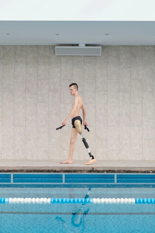 a man walking next to a swimming pool, by James Morris, prosthetic, sport, camo, conor walton