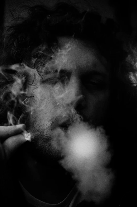 a black and white photo of a man smoking a cigarette, by Thomas Wijck, zack de la rocha, metatron, fires glow lonely, 4 2 0